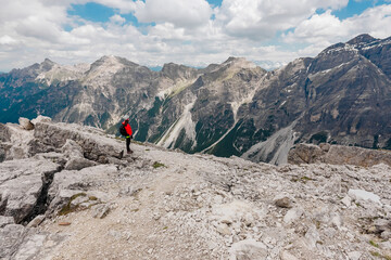 Alpine Landscape with a HIker Standing on the Summit