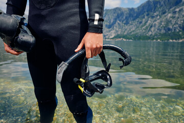 Diver stands in the shallows