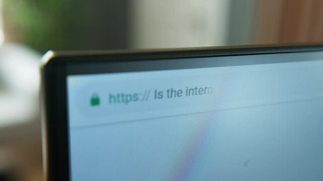 Close-up view of a computer monitor displaying a web browser with the search query "is the internet reliable?" in the address bar. Seeking information about the reliability of internet services