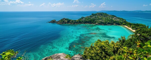 Stunning aerial view of a tropical island surrounded by turquoise water, lush greenery, and a pristine sandy beach under a clear blue sky.