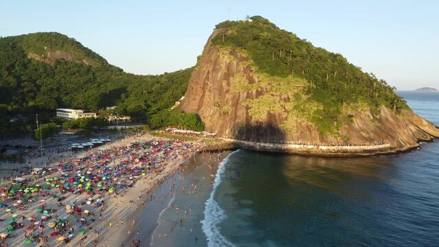Leme beach and Leme hill at sunset, Rio de Janeiro, Brazil. Aerial perspective, drone footage.