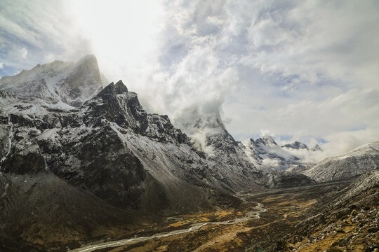 Majestic snow-capped mountains with cloudy sky