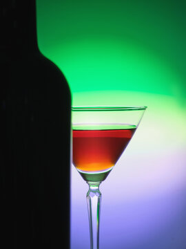 Elegant empty martini glass on a colored gradient 