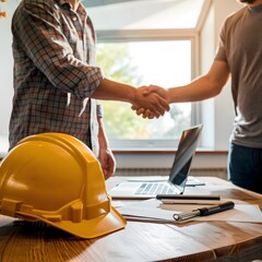 Yellow hard hat on table with laptop, papers, individuals shaking hands For Social Media Post Size