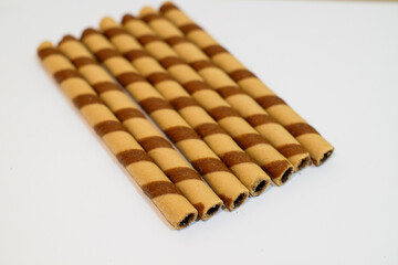 wafer rolls with chocolate isolated on white background, sweet food, snack food, copy space.