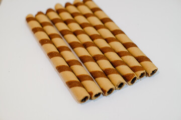 wafer rolls with chocolate isolated on white background, sweet food, snack food, copy space.