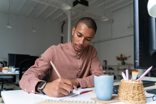 Queer man working at office