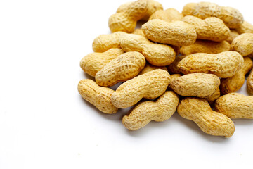 Roasted peanuts in shell on white background.