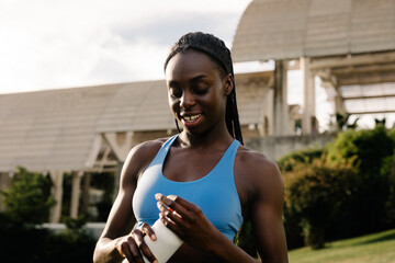 Medium shot of a runner with diastema holding a water bottle