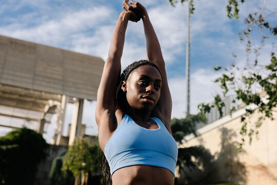 Athlete performs body stretches after an exercise routine in a park