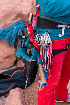Climber with drill an bolting equipment, climbing adventrure