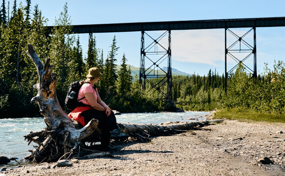 hiker sitting on log 