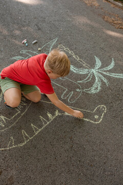 boy drawing crayons outdoor