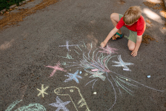 boy drawing crayons outdoor