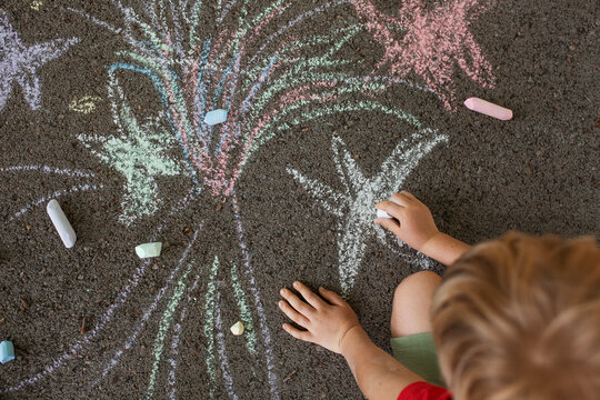 boy drawing crayons outdoor