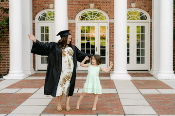 middle aged happy college graduate with her daughter 