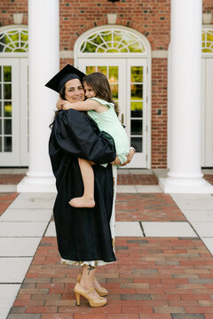 middle aged happy college graduate with her daughter 