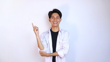 Excited young Asian man gesturing pointing upwards