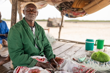 Fisherman repairing nets in senegal