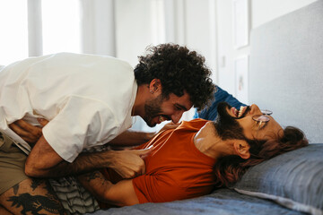 Affectionate gay couple embracing at home