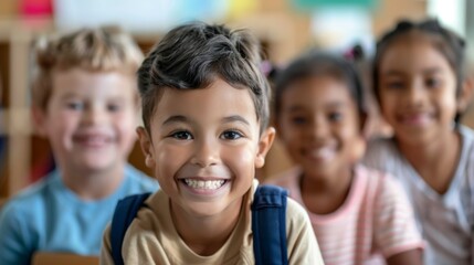 A group of happy children smiling broadly, posing together in a colorful classroom setting, exuding joy and companionship during a school day.