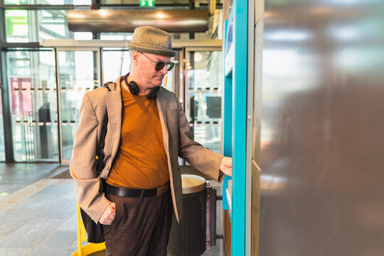 Middle age man in a teller machine