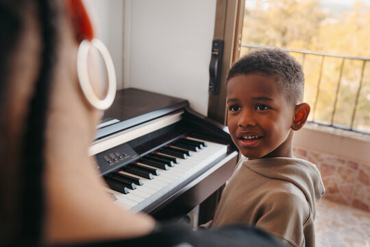Curious kid learning piano portrait