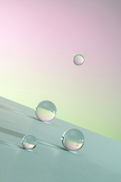 falling glass balls on light background