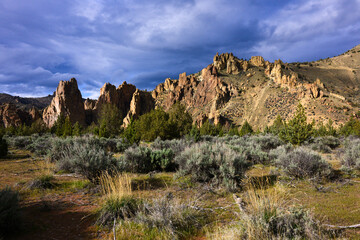 Rocky landscape at Smith Rock State Park glowing under moody sky