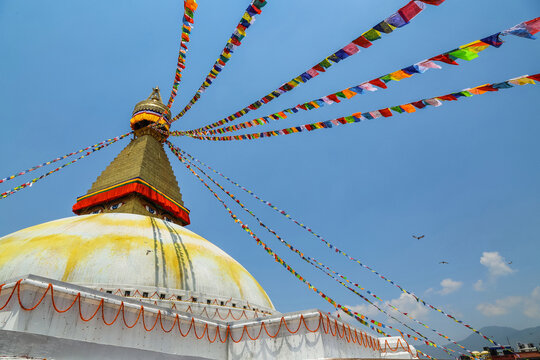 Boudhanath stupa with colorful prayer flags on a bright day