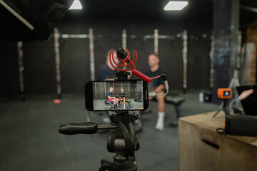 Behind-the-scenes fitness vlogging setup in gym