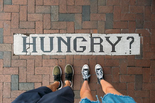 Hungry Sign on City Sidewalk 