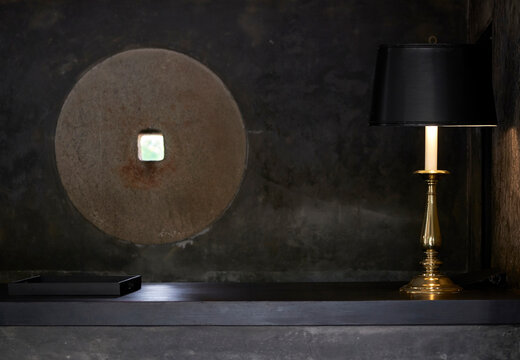 Close up black table lamp on black stone interior background