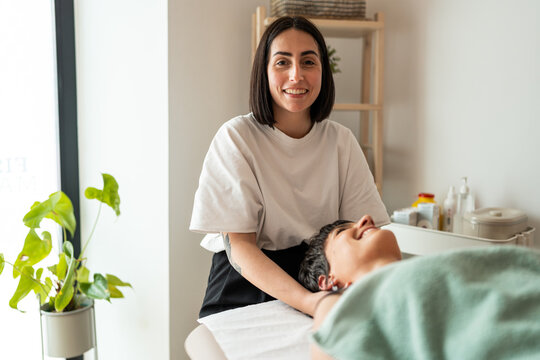 Female masseuse smiling.