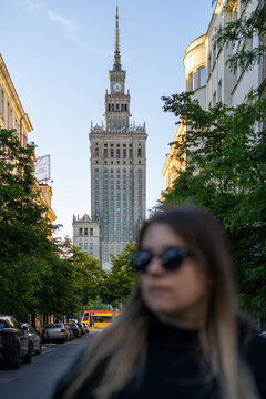 Young woman in Warsaw with Palace of Culture and science on background