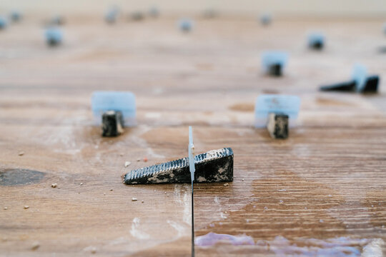 Tile levelling clips ready for use during renovation of hall