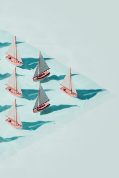 Sailboats Arranged in Diagonal Pattern on Water