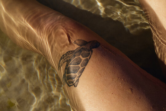 Close up of thigh with turtle tattoo