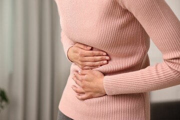 Indigestion problem. Woman suffering from stomachache, closeup
