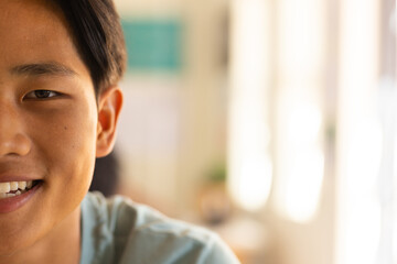 Smiling teenage boy in high school, focusing on classroom activities and learning, copy space