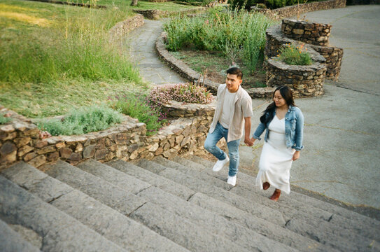 Film photo of couple together outside walking 