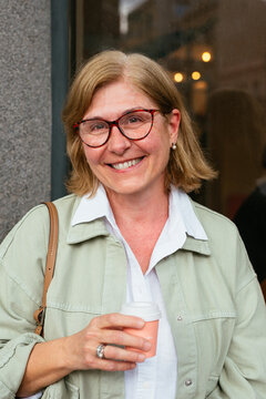 Senior woman smiling with a coffee in the hand