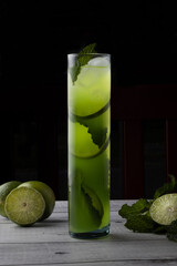 green cocktail with herbs and lemons