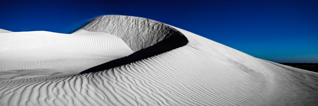 Last light over large pure white sand dune