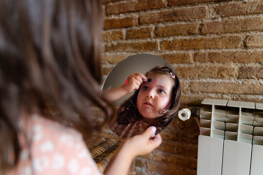Little Girl Playing with Makeup at Home