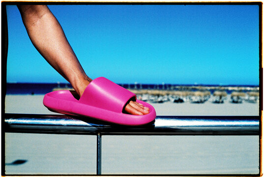 man wearing a sandal in his hand, 35mm film