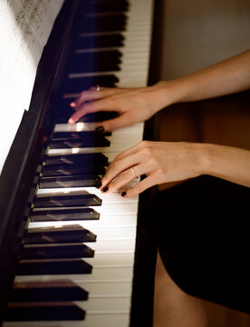 Woman playing the piano at home 