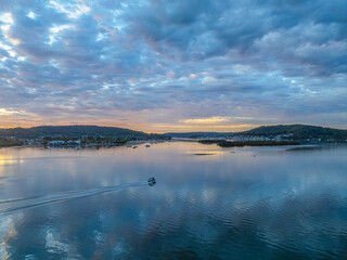 Sunrise over the bay water with clouds and reflections