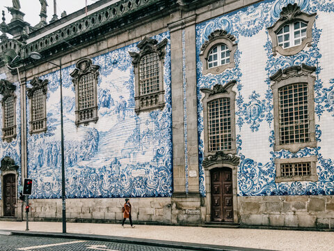 Woman Walking by Azulejo Tile Wall in Porto
