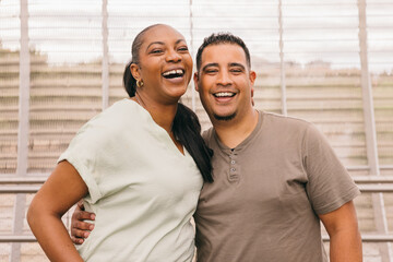 Curvy Dominican couple sharing a joyful moment outdoors